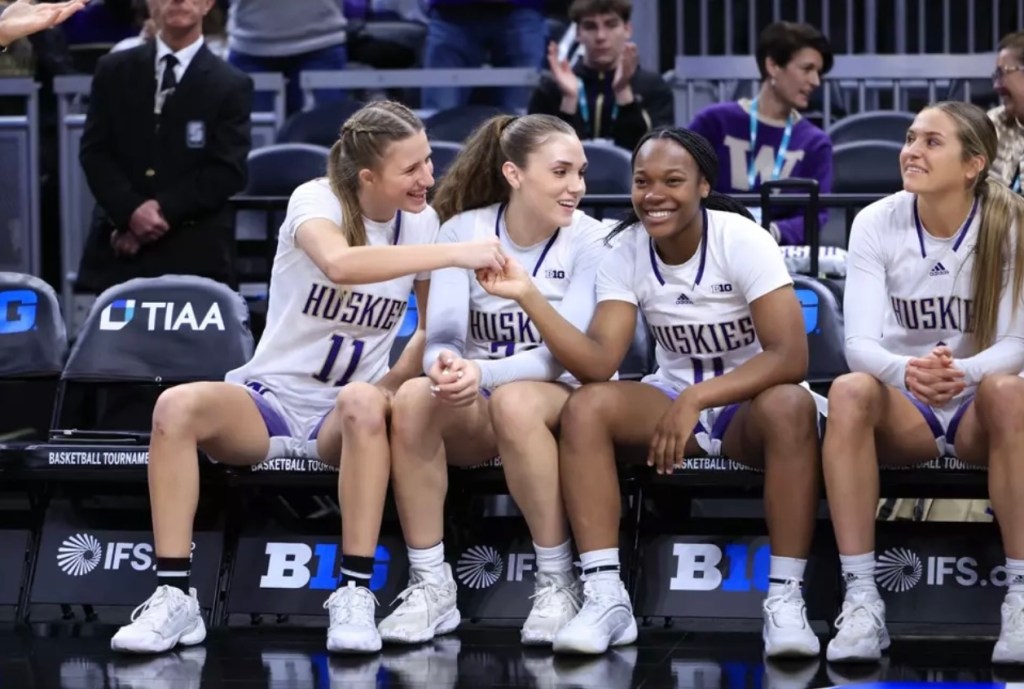 UW guards Chloe Briggs, Elle Ladine, Sayvia Sellers and Hannah Stines sit on the bench ahead of their Big Ten Tournament First Round matchup against Minnesota at Gainbridge Fieldhouse in Indianapolis, Ind. on March 5, 2025.